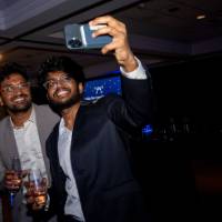 Three grads take selfie with champagne